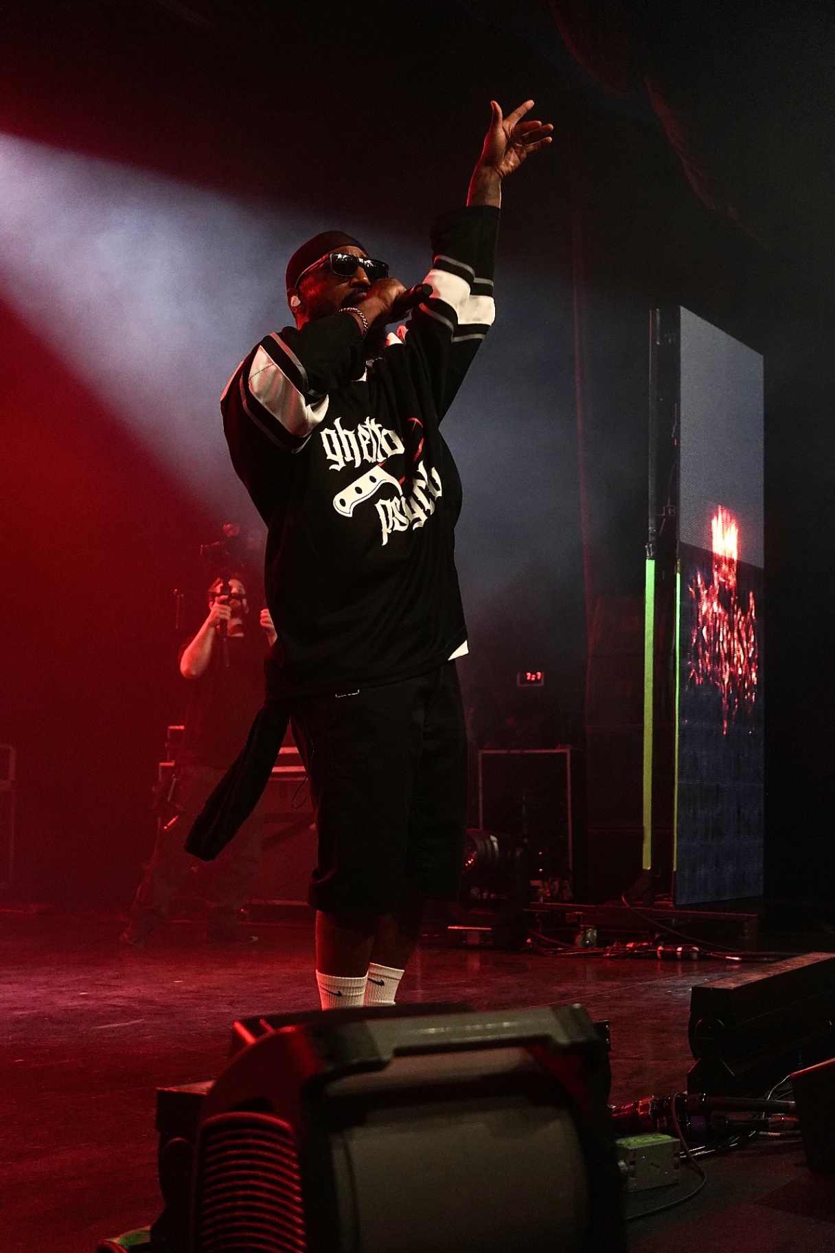 Artist reaching to the crowd in red light