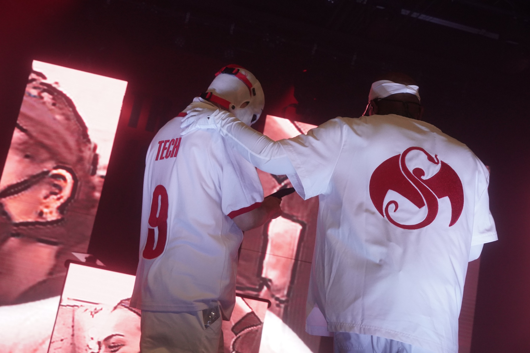 Tech N9ne and Krizz Kaliko from behind in Strange Music jerseys